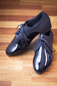 High angle view of formal shoes on hardwood floor