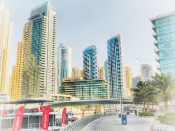 Modern buildings in city against clear sky