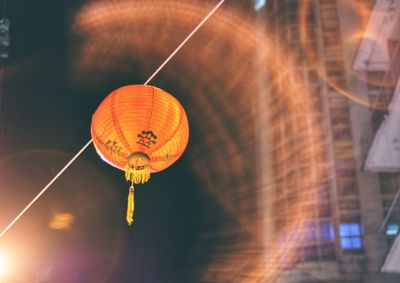 Illuminated lantern hanging at night