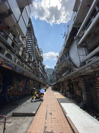 Street amidst buildings in city against sky