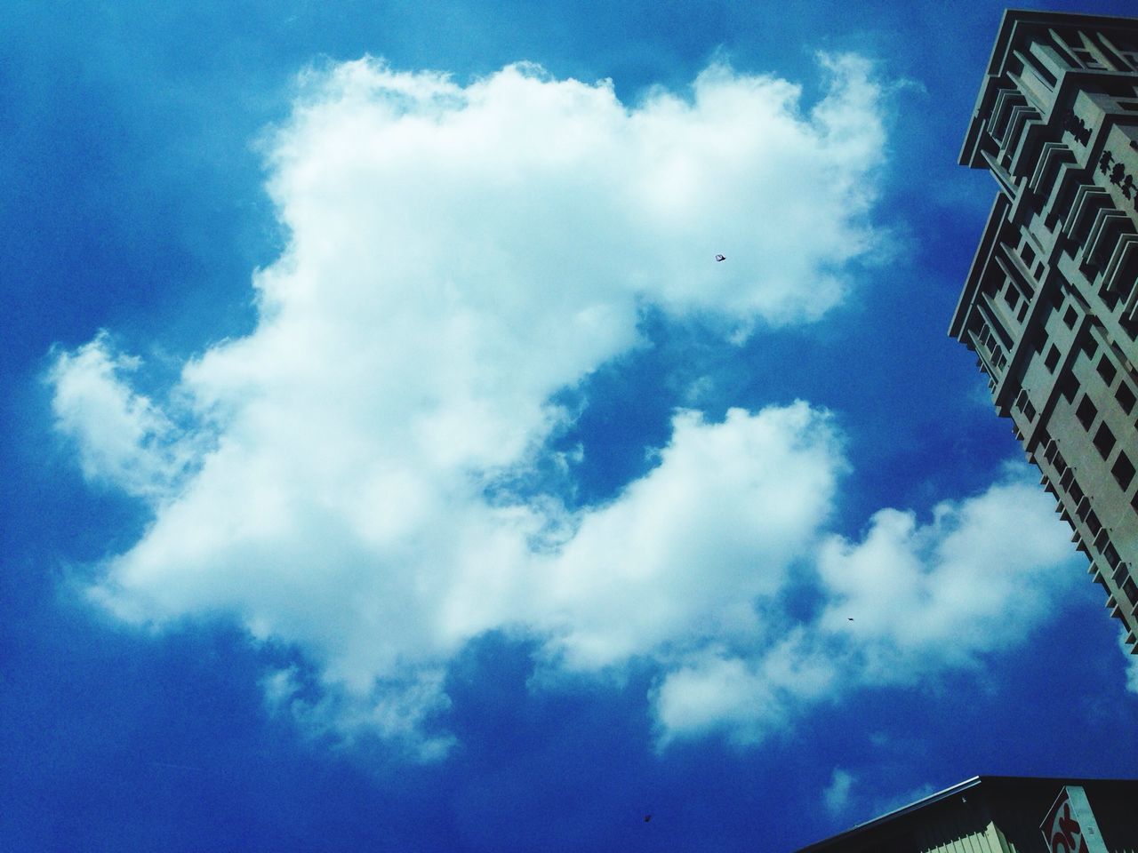 low angle view, sky, architecture, built structure, building exterior, blue, cloud - sky, cloud, cloudy, building, high section, outdoors, day, city, no people, modern, directly below, tall - high, nature, tower