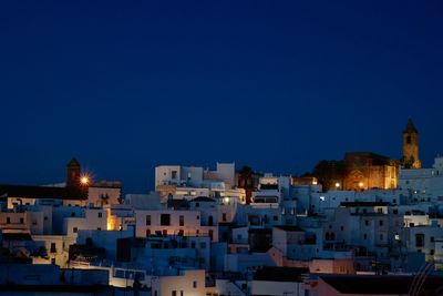 Illuminated buildings against clear sky
