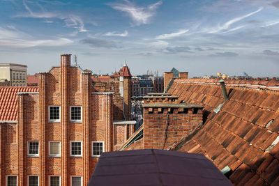 High angle view of buildings against cloudy sky