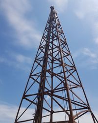 Low angle view of communications tower against sky