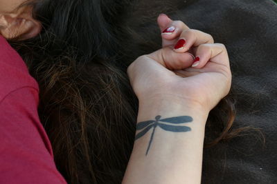 Woman with tattooed hand and long hair