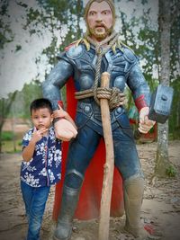 Full length portrait of boy standing outdoors