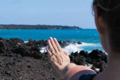 Close-up of hand of a woman on seashore