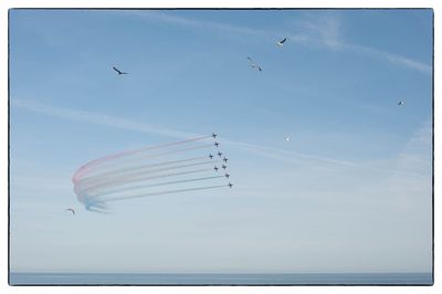 Low angle view of airplane flying against sky