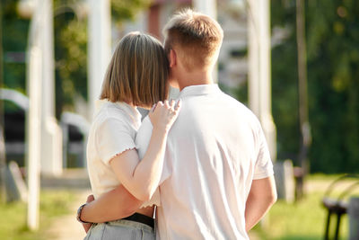 Rear view of couple standing outdoors