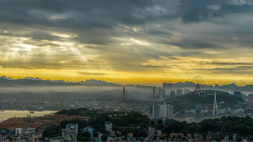 High angle view of buildings in city during sunset