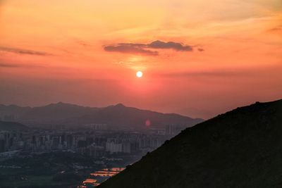 Scenic view of sunset over city