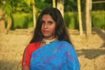 Portrait of beautiful woman standing on land