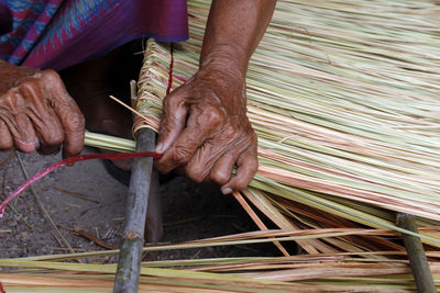 Man weaving straw at workshop