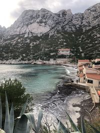 Scenic view of lake by mountains against sky