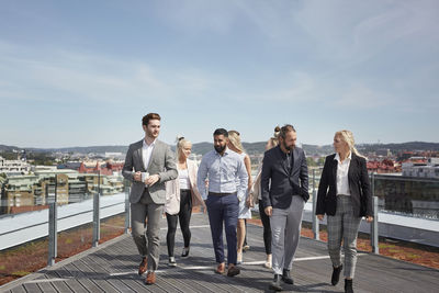 Coworkers walking on terrace