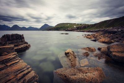 Scenic view of mountains against cloudy sky