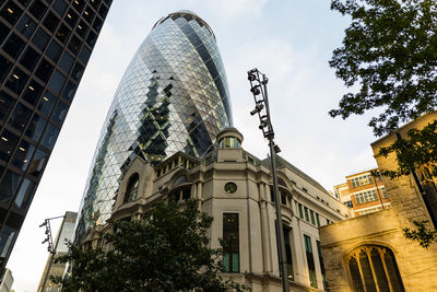 Low angle view of buildings against cloudy sky