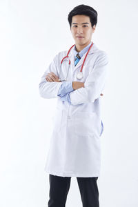 Portrait of teenage girl standing against white background