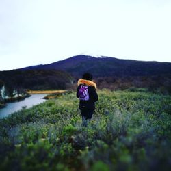 Rear view of woman standing on landscape