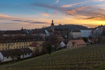 Buildings against cloudy sky at sunset