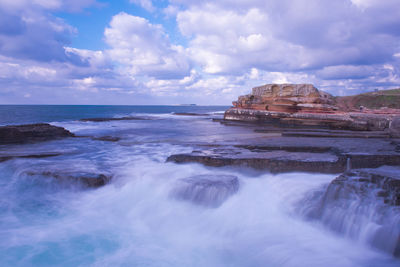 Scenic view of sea against cloudy sky