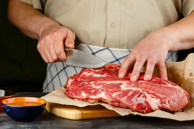 Close-up of person preparing food on table