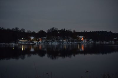 Scenic view of lake against sky at night