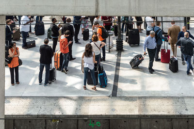 People walking on railroad station platform