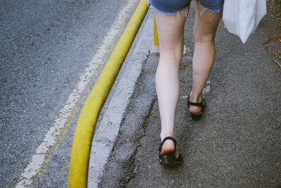 Low section of people walking on road