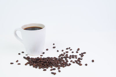 Close-up of coffee beans against white background