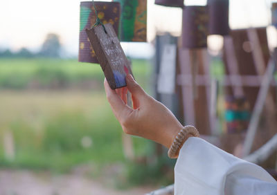 Close-up of hand holding cigarette