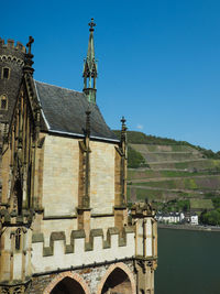 Low angle view of built structure against clear blue sky