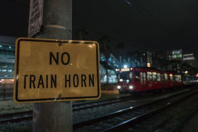 Information sign on railroad tracks at night
