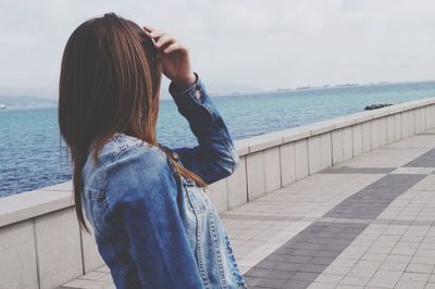 Rear view of woman standing at promenade