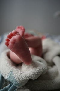 Close-up of baby hand on bed