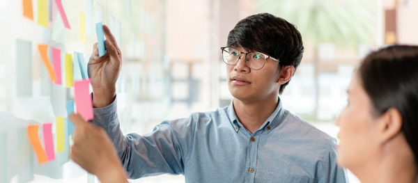 Side view of young woman using mobile phone