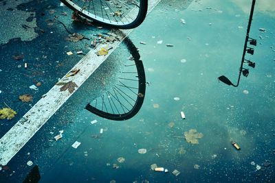 High angle view of wet glass on street