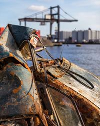 Close-up of abandoned car against sky