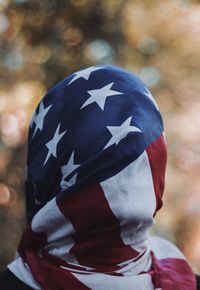 Close-up of person covered with american flag