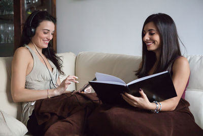 Happy women relaxing on couch at home
