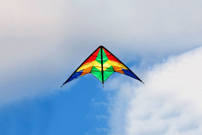 Low angle view of kite flying against sky