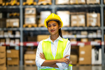 Portrait of young woman standing in supermarket