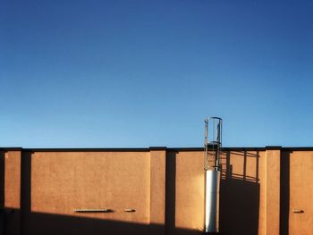 Low angle view of building against clear blue sky