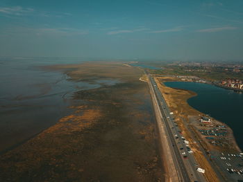 High angle view of road by sea against sky