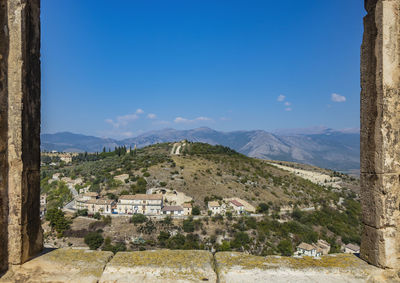 Scenic view of mountains against blue sky