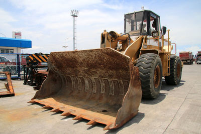 Construction site by road against sky