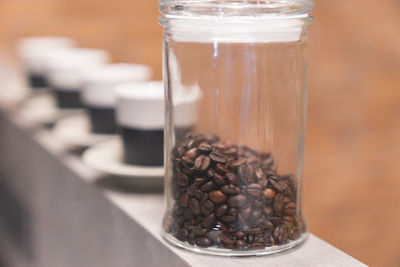 Close-up of coffee in glass jar on table