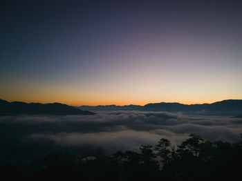 Scenic view of silhouette mountains against sky during sunset