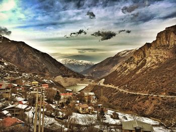 Scenic view of mountains against cloudy sky