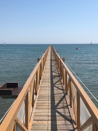 Pier over sea against clear sky